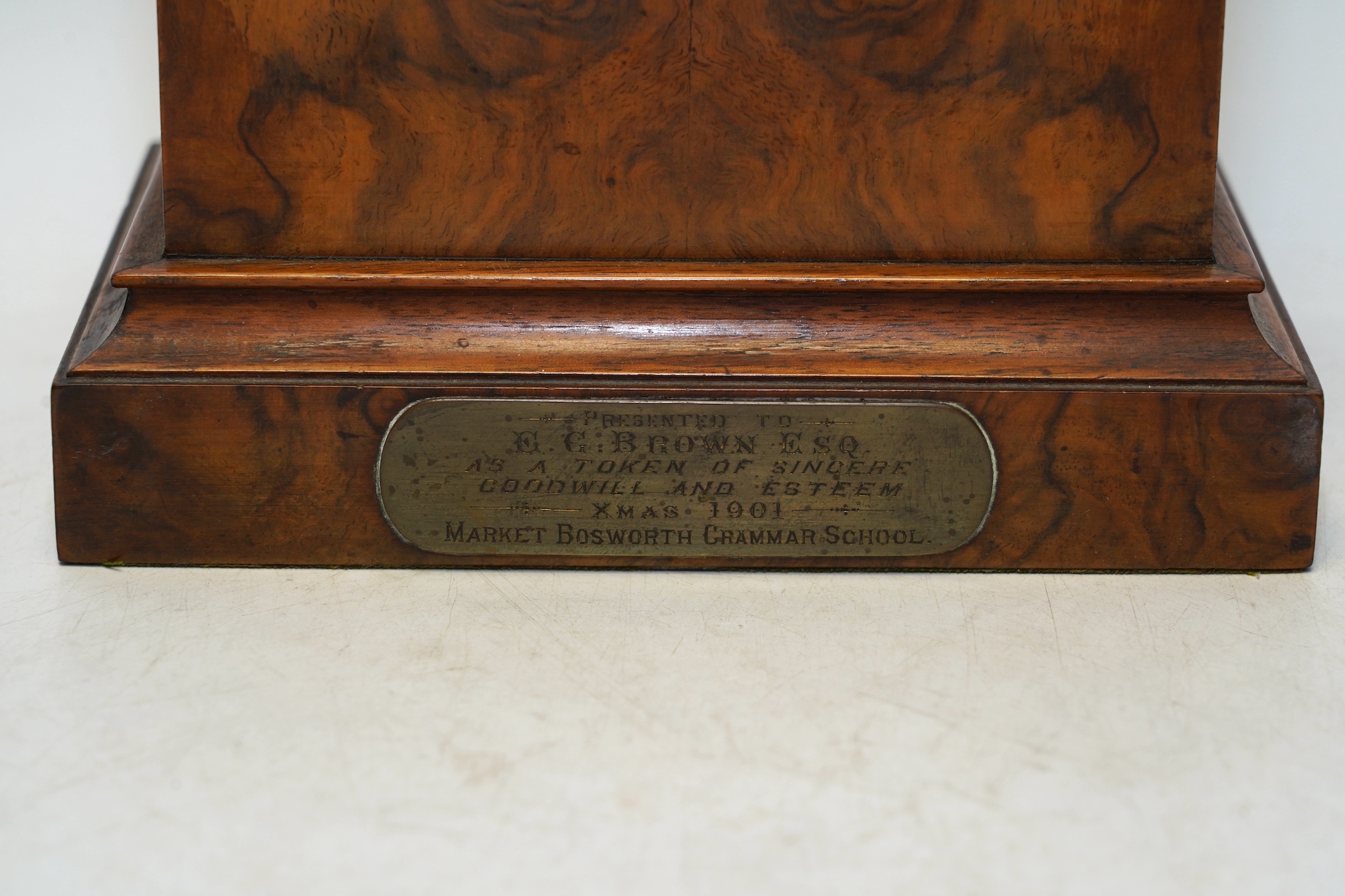 An Edwardian mantel clock with Arabic dial and applied plaque, 25cm high. Condition - fair to good, some cracking to the wood